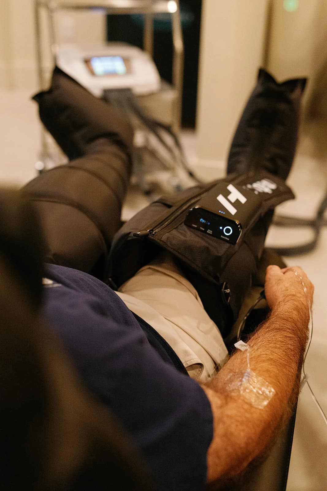 Normatec compression boots during an IV infusion at OutRecover