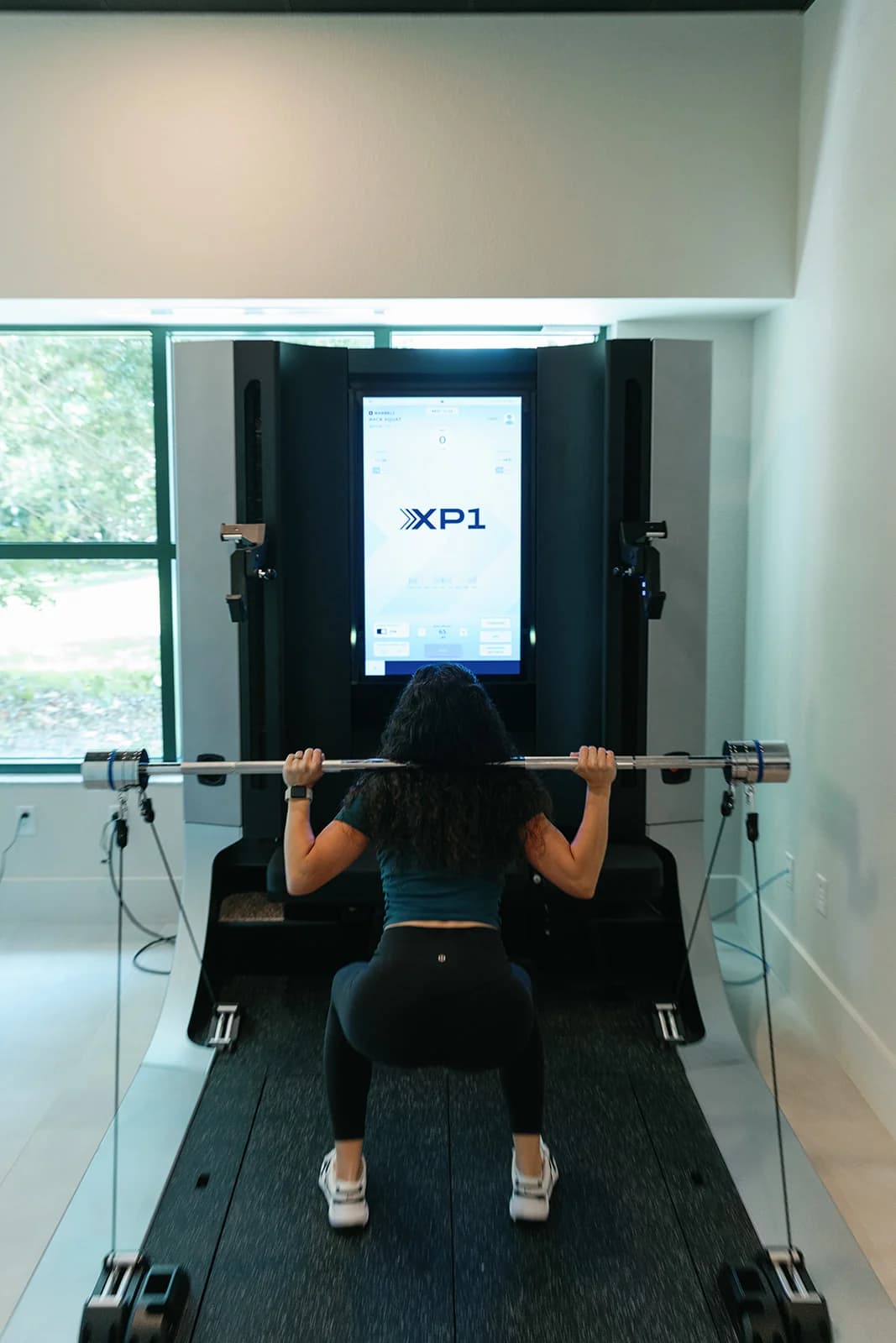 Client training on the OxeFit XP1 strength system at OutRecover