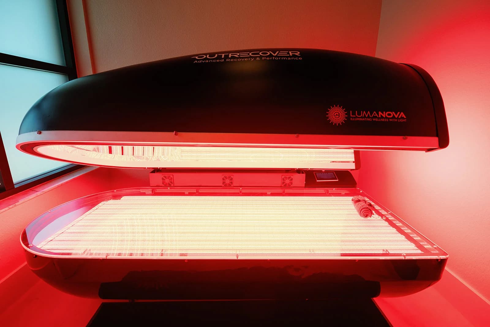 The LumaNova full-body red light therapy bed at OutRecover in Naples, FL